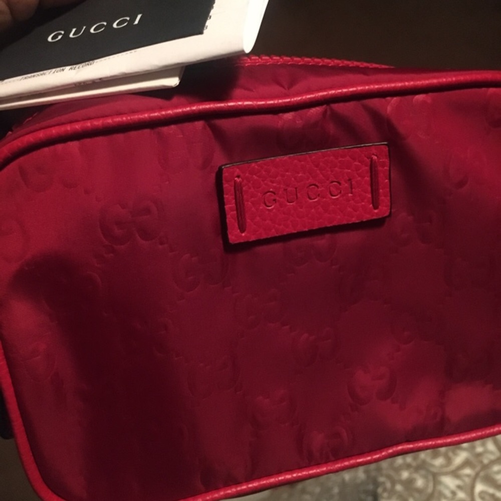 Gucci toiletry bag in a red color-way. Gently used. No stains. No flaws.